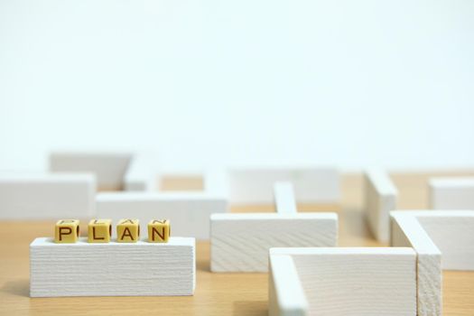 Business strategy conceptual photo – wooden beads word Plan above labyrinth maze. Image photo