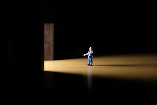 Business conceptual photo – miniature of businessman entering office building. Image photo