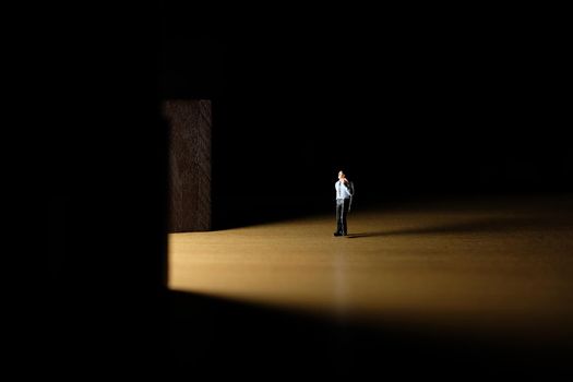 Business conceptual photo – miniature of businessman entering office building. Image photo