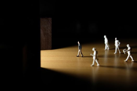 Business conceptual photo – Selective focus, miniature of businessman entering office building. Image photo