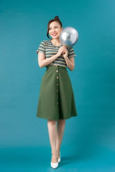 Portrait of attractive woman with silver balloons