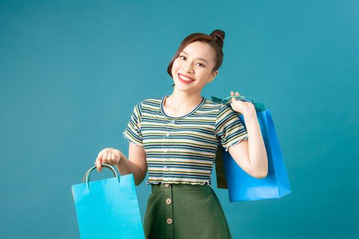 Young happy smiling woman with shopping bags