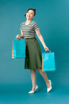 Young happy smiling woman with shopping bags