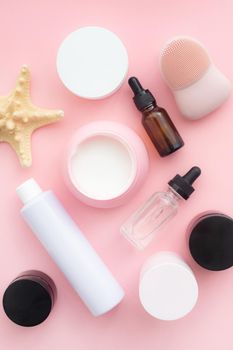 Layout on a pink cream background . Cosmetology. Care cosmetics. Skin care. Jars of cream. Pink background. Copy space. Article about the choice of cream. Spa. Spa treatments .