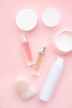 Layout on a pink cream background . Cosmetology. Care cosmetics. Skin care. Jars of cream. Pink background. Copy space. Article about the choice of cream. Spa. Spa treatments .