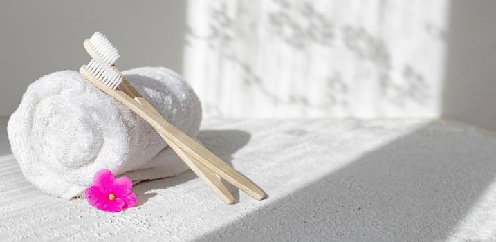 Bamboo brushes and towels . Light and shadows. Spa treatments. Concern for the environment . Bath treatments. Article about the spa . Copy space