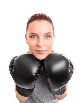 Close up of a beautiful young woman with boxing gloves looking at the camera, isolated on white background. Martial arts, sport concept.