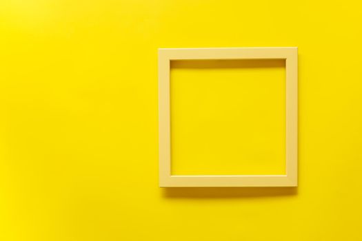 Yellow vintage frame on yellow background. Top view, blank space