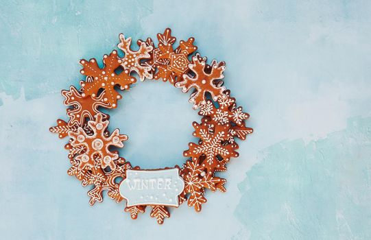 Christmas gingerbread snowflakes cookies with decoration on rustic blue  background. Circle shape. Christmas and New Year tradition concept