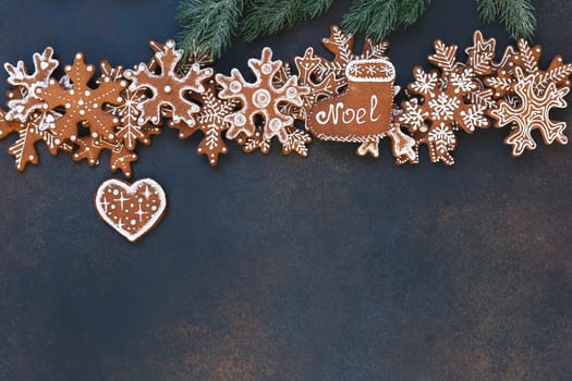 Christmas gingerbread snowflakes  and heart shaped cookies with decoration on rustic dark background. Christmas and New Year tradition concept