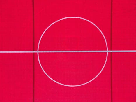 Plastic outdoor basketball court  floor, detail. Outdoor sport ground with red surface for playing basketball  in urban area, above.