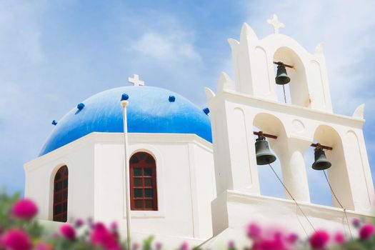 Orthodox church with blue dome in Oia on Santorini island, Greece