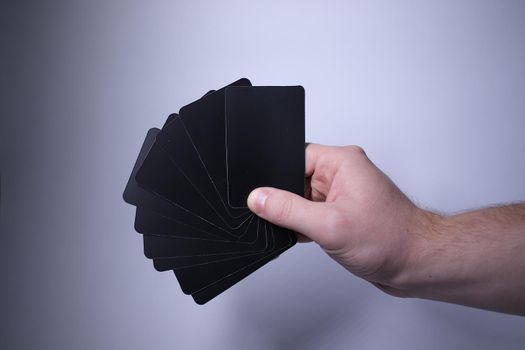 Black playing cards on a grayish background. Board games. Hanging out with friends. High quality photo