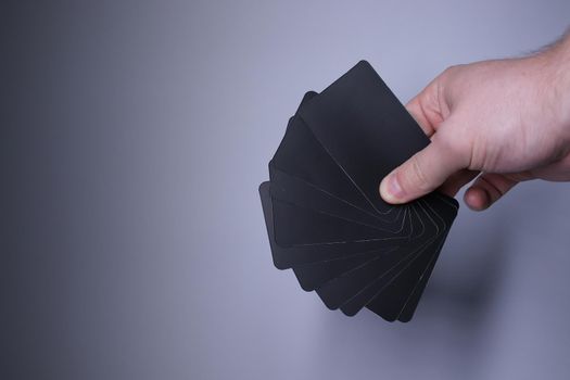 Black playing cards on a grayish background. Board games. Hanging out with friends. High quality photo