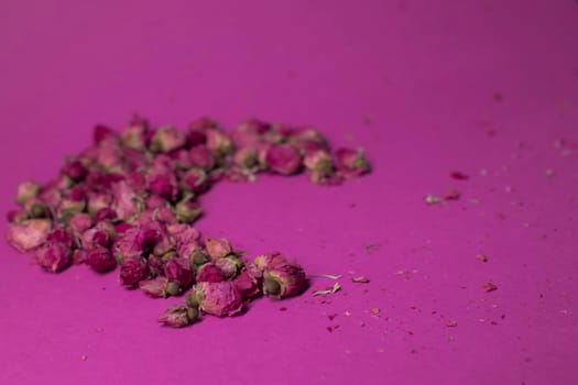 A lot of little pink roses on a pink background - moon-shaped - horizontal photo