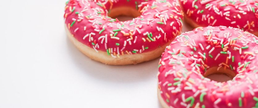 Bakery, branding and cafe concept - Frosted sprinkled donuts, sweet pastry dessert on marble table background, doughnuts as tasty snack, top view food brand flat lay for blog, menu or cookbook design