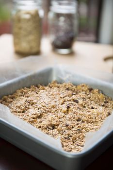 Baking pan full of quinoa and oat bars dough ready for baking