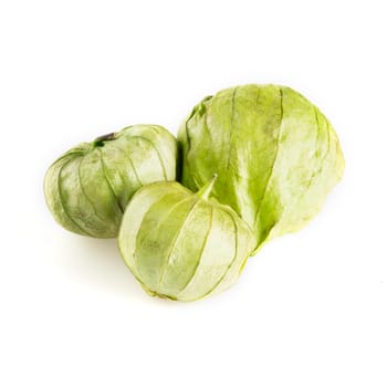 Three tomatillos isolated on a white background.