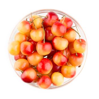 Rainier Cherries in a bowl, isolated on white and viewed from above.