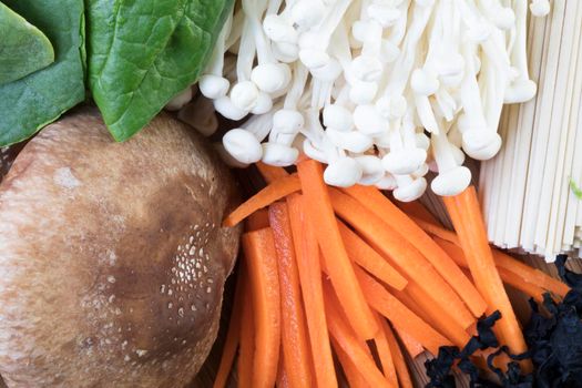 Ingredients for Udon: shiitake mushrooms,  enoki mushrooms, carrots, udon noodles, wakame, and spinach