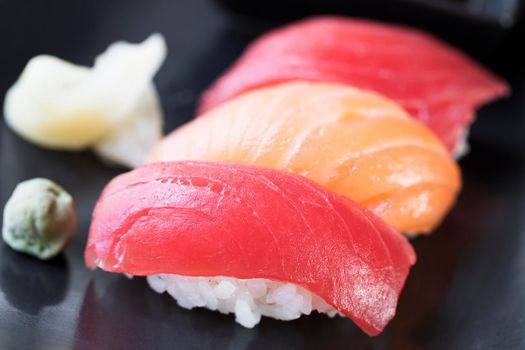 Tuna ans salmon nigiri sushi rolls with ginger and wasabi