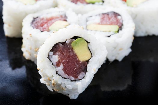 Fresh tuna and avocado uramaki sushi rolls.