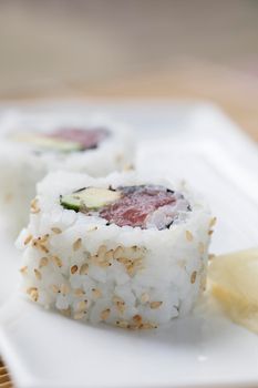 Fresh tuna and avocado uramaki sushi rolls.