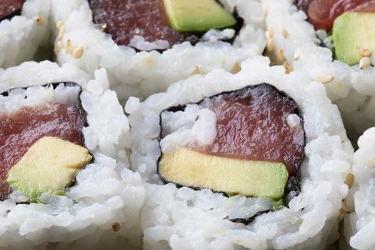 Fresh tuna and avocado uramaki sushi rolls.