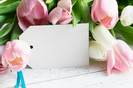 Pink and white tulips and gift card with copy space.