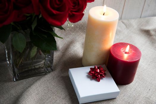 Gift box and two candles with roses