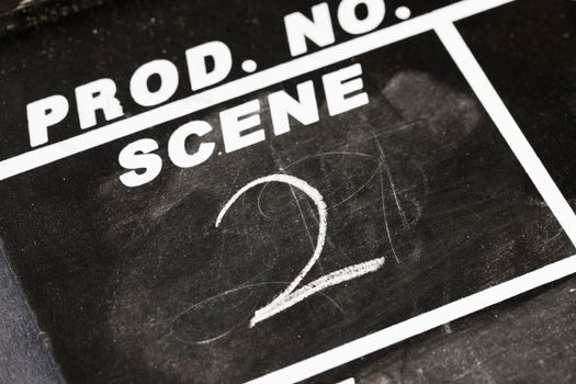 Close up of chalk board film production clapper marked  with scene two.