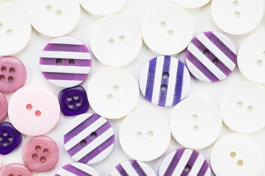 Colorful button texture with pink, purple and white buttons.