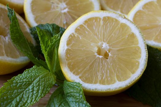 Lemon halves with fresh mint leaves close up