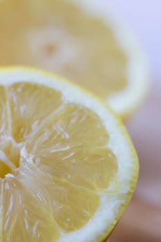 Close up of lemon sliced in half, vertical orientation.