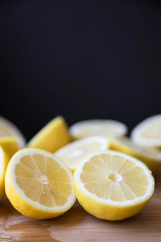Bright lemon halves with dark copy space and vertical orientation