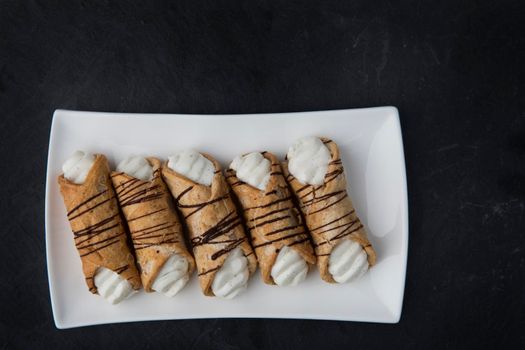 Pastries Stuffed with sweet cream and drizzled with chocolate.