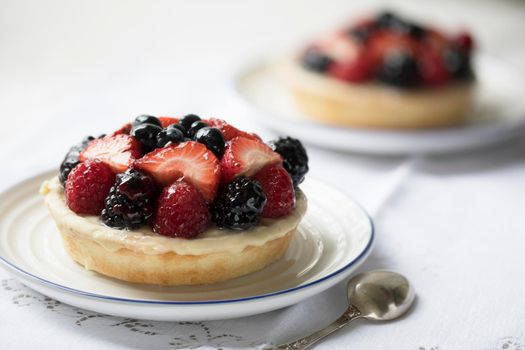 Tempting mixed berry tart with blackberries, raspberries, blueberries and strawberries.