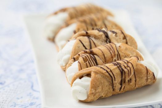 Pastries Stuffed with sweet cream and drizzled with chocolate.