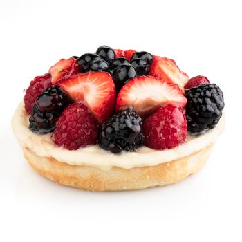 Mixed berry tart isolated on a white background with shadow.