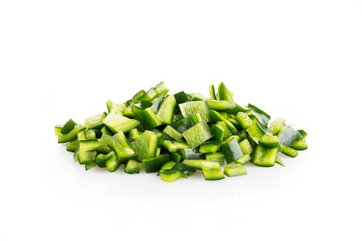 Fresh chopped poblano peppers on white background with shadow.