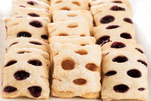 Rows of raspberry and apple filled mini strudels.