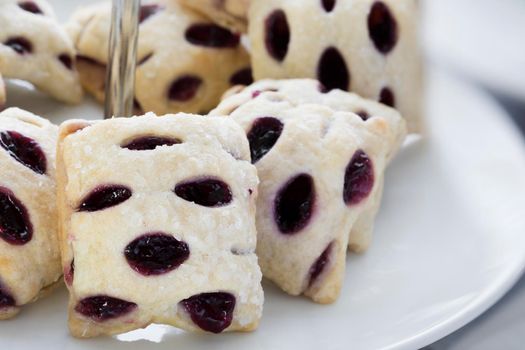 Berry filled mini strudels on a pastry stand