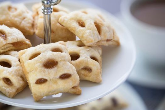 Peach or apple filled mini strudels on a pastry stand.