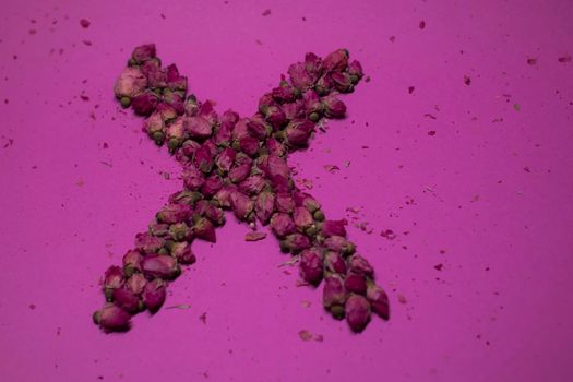 A lot of little pink roses on a pink background - X-shaped - horizontal photo