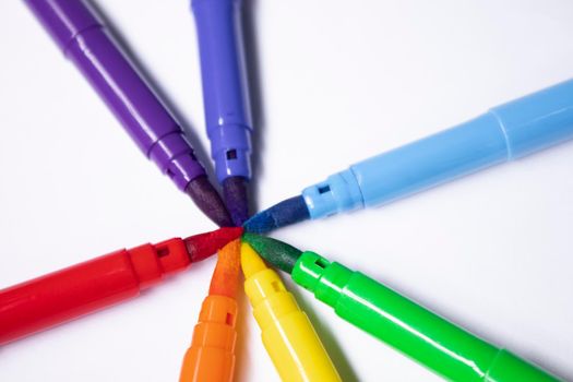 a bunch of colored markers laid out in rainbow order. stationery concept. copy space. isolated. High quality photo