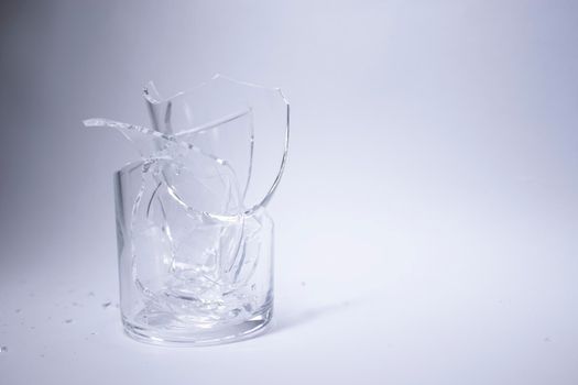 fragments of a broken glass in a broken glass on a white background. Isolated. Copy space. High quality photo