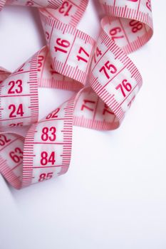 Red measuring tape on white background. Loss weight concept. Top view. Copy space. Isolated. . High quality photo