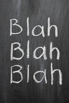  blah word 3 times handwritten on blackboard