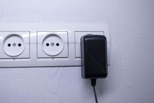 Sockets for electrical appliances on a light gray wall. a multifunction outlet. High quality photo