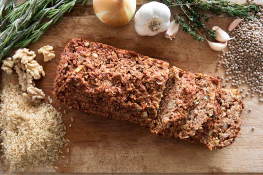 Lentil loaf on cutting board with ingredients view from above.